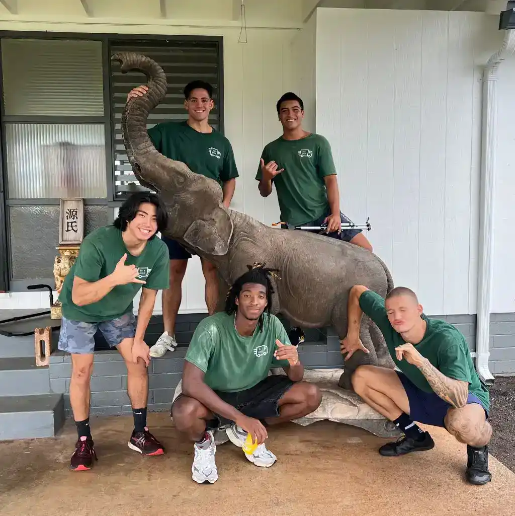Bill's Moving and Shipping standing next to a statue of an elephant